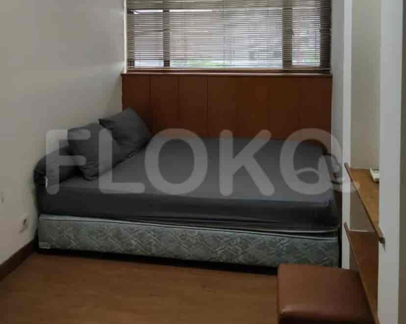 Bedroom with a single bed, window, and headboard.