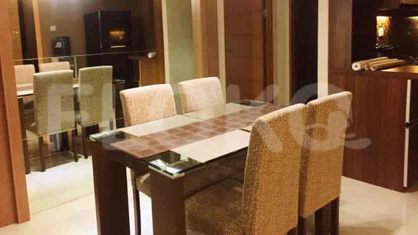 A dining area featuring a glass-top table with six chairs.