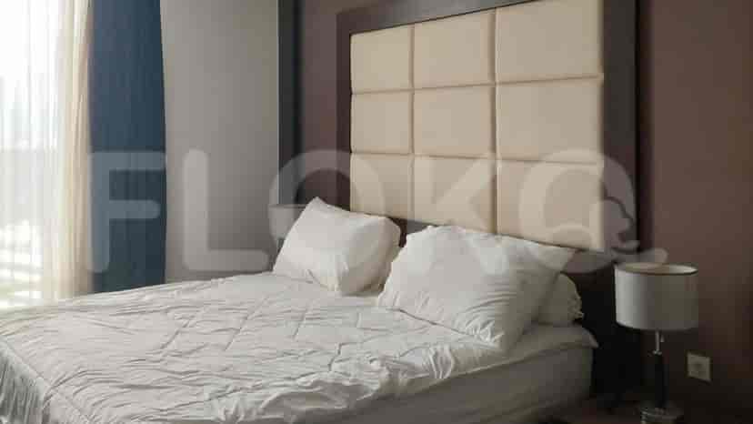 Bedroom featuring a bed with a cushioned headboard.
