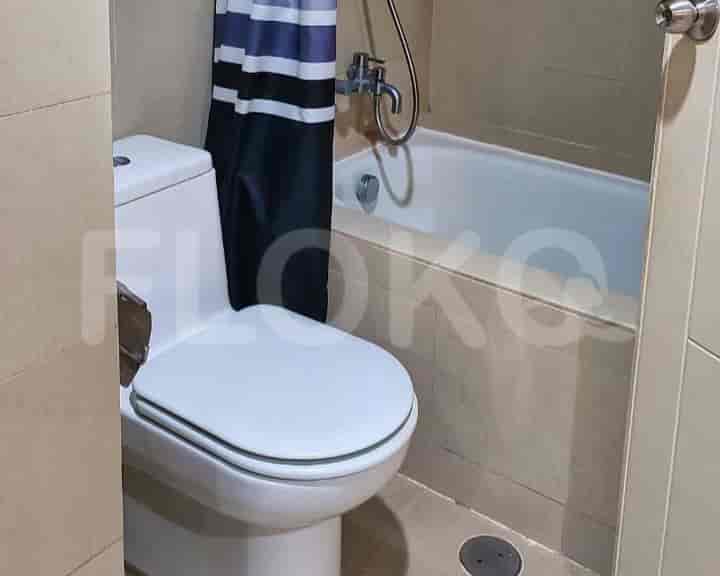 A bathroom with a toilet, bathtub, and shower curtain.