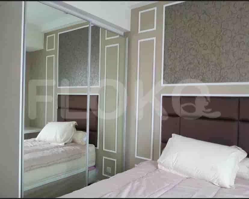 A modern bedroom featuring a double bed, a wardrobe and decorative walls.