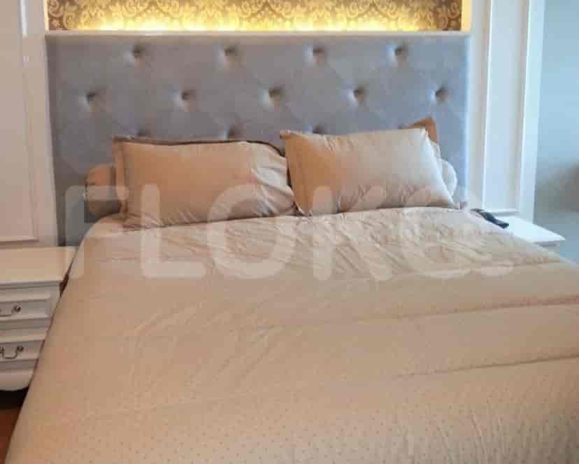 A contemporary bedroom with a large bed and neutral color scheme.