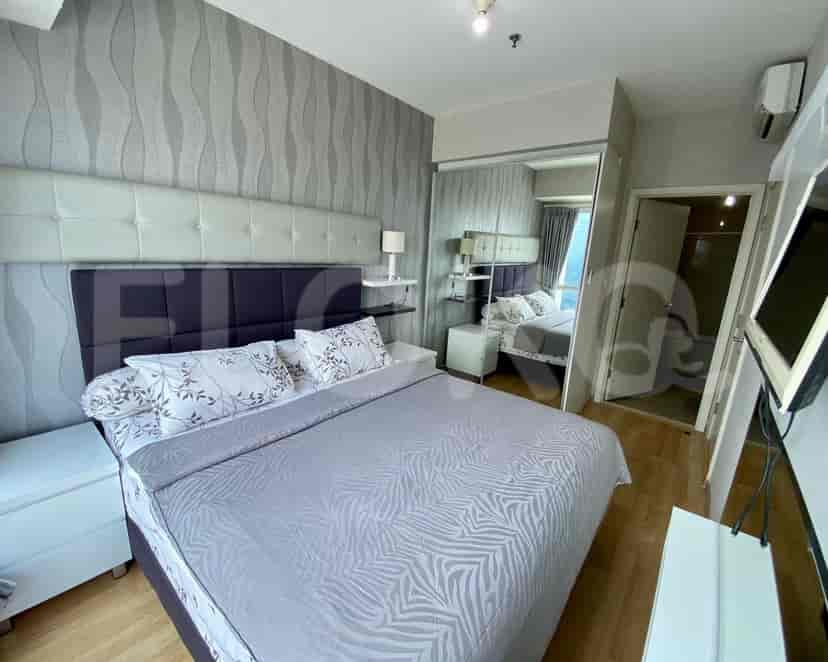 Stylish bedroom with a king-size bed and mirror closet.