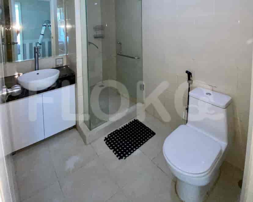 Modern bathroom featuring a glass-enclosed shower and a white toilet.