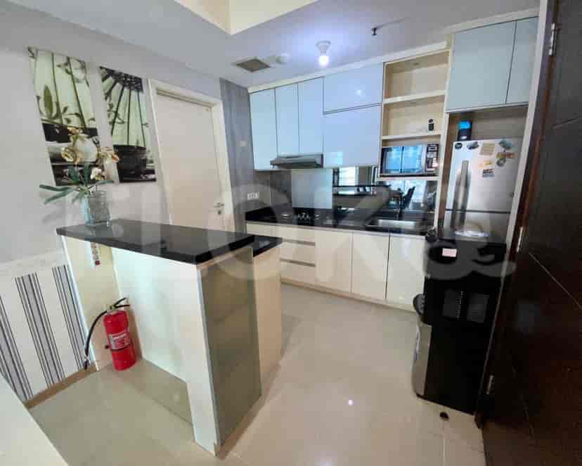 Contemporary kitchen with white cabinets and a breakfast bar.