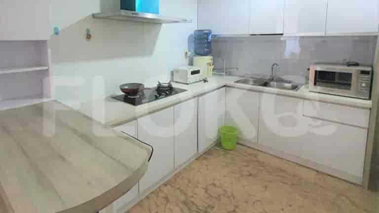 A fully equipped kitchen with white cabinets, a gas stove, and a microwave.