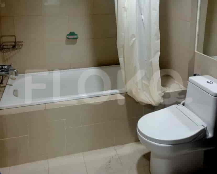 A simple bathroom with a bathtub and toilet.