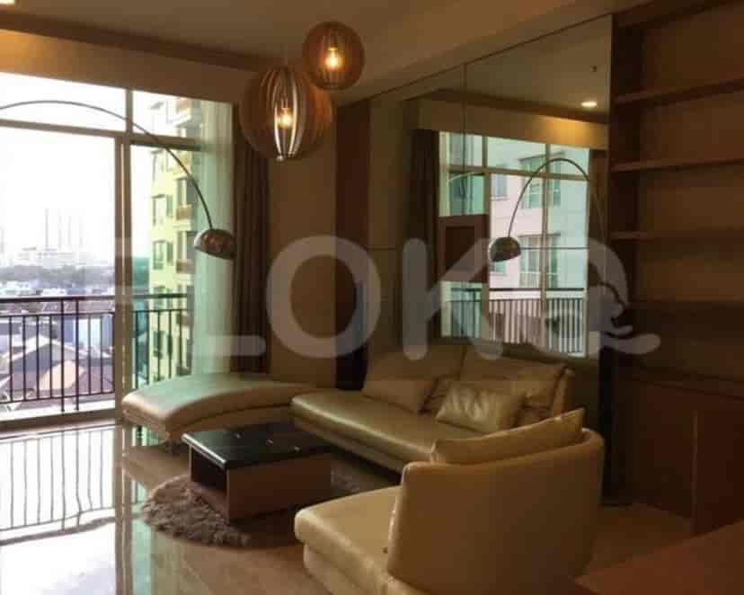 Living room with a sofa, coffee table, and large window.