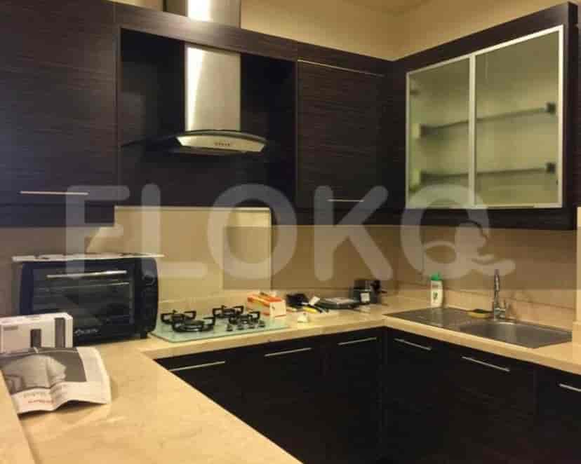 Modern kitchen with dark cabinets and appliances.