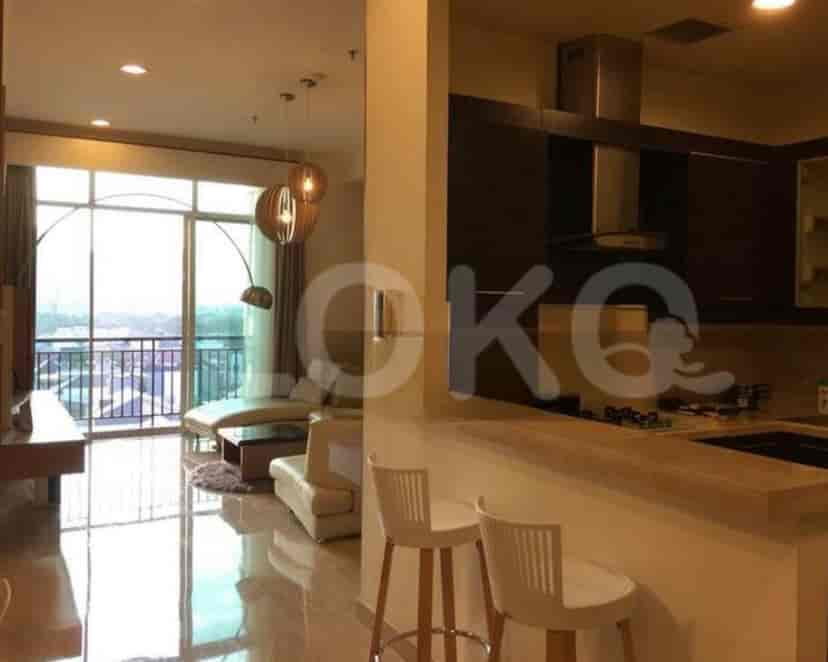 A view of the living area with kitchen in the background.