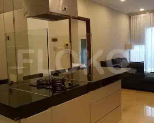 A modern kitchen with a kitchen island, gas stove, and white cabinets.