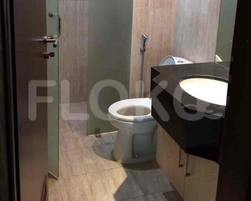 A small bathroom with a toilet, sink, and shower.