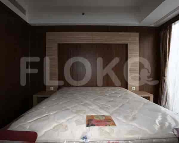 Bedroom with a bed and a large headboard.