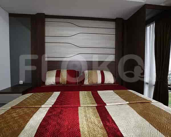 Bedroom with a bed and decorative headboard.