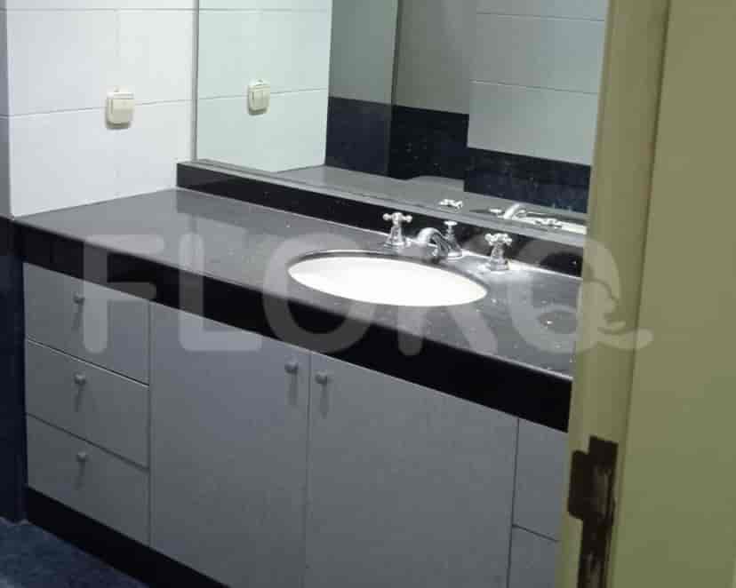 A bathroom with a vanity unit, mirror, and sink.