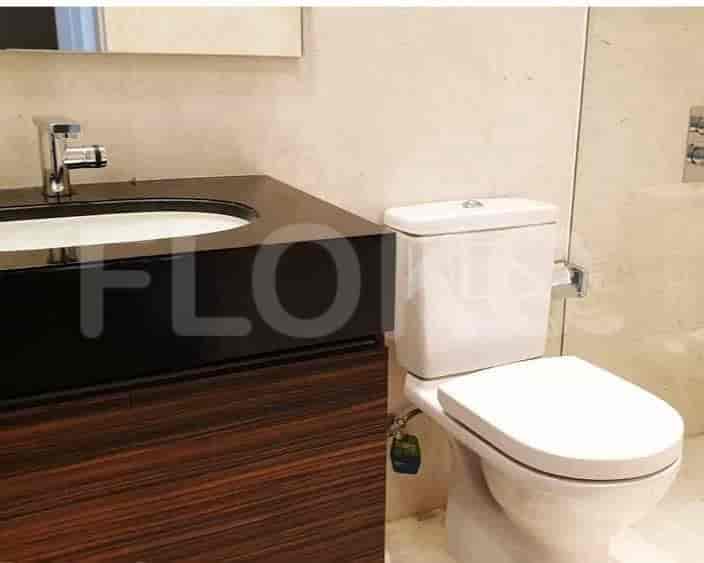 A bathroom with a white toilet and sink.