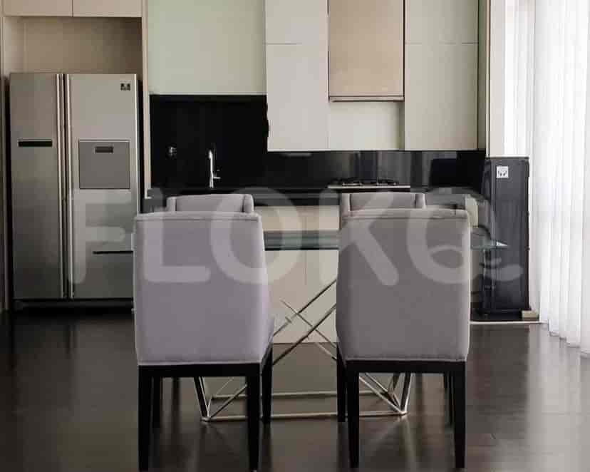 A modern kitchen with a dining table and chairs.