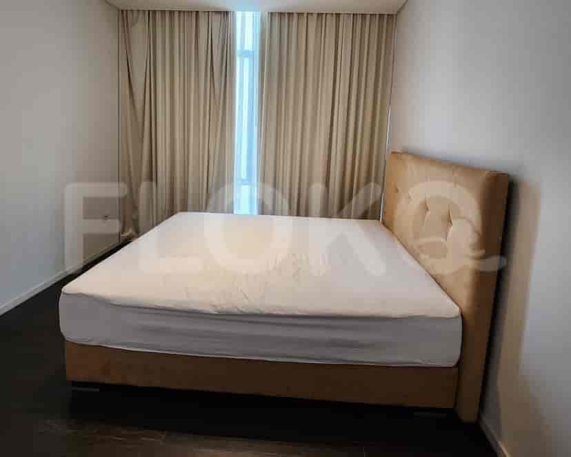 Bedroom with a bed and curtains.