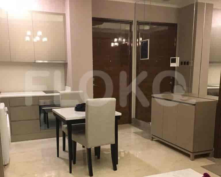 A kitchen with dining table and cabinets.