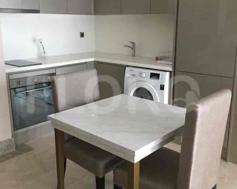 A kitchen with a table, chairs, cabinets, and appliances.