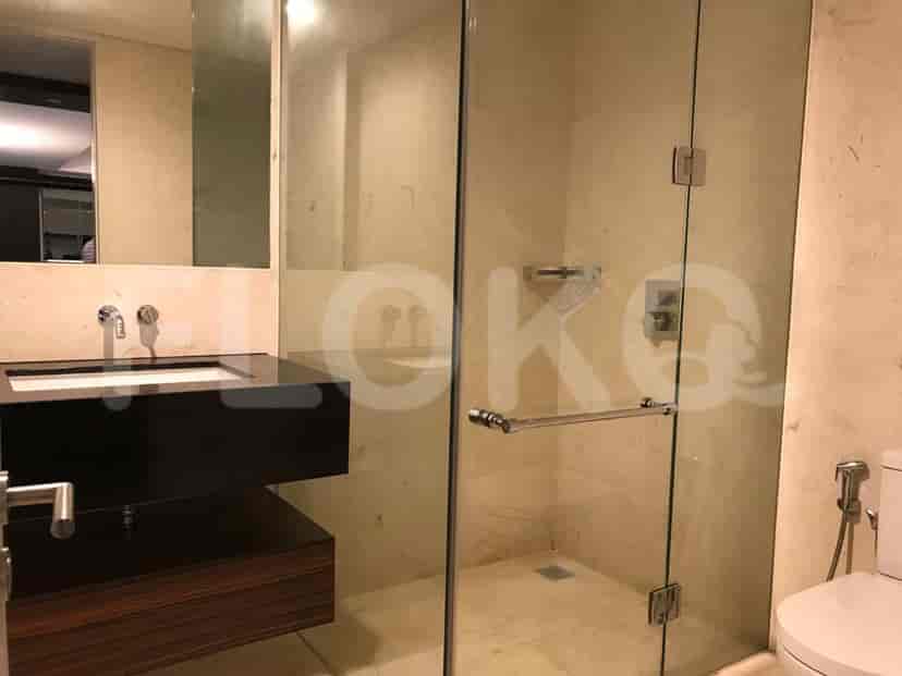 A bathroom with a shower, vanity, and toilet.