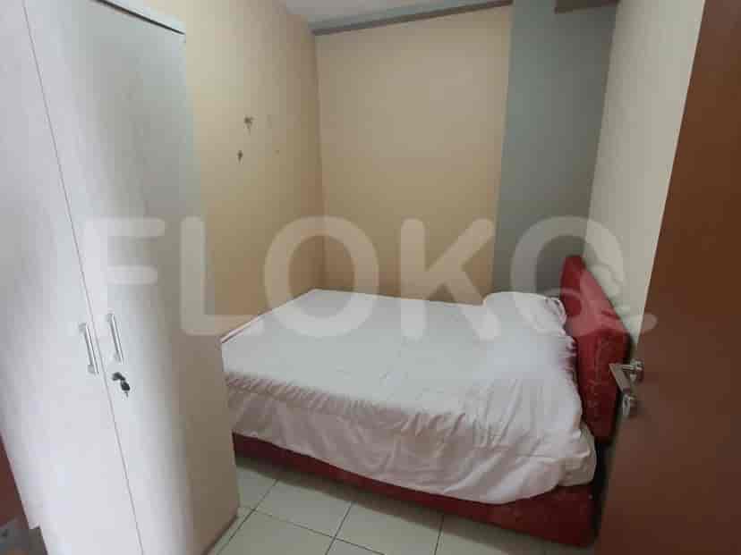 A secondary bedroom with a double bed and a wardrobe.