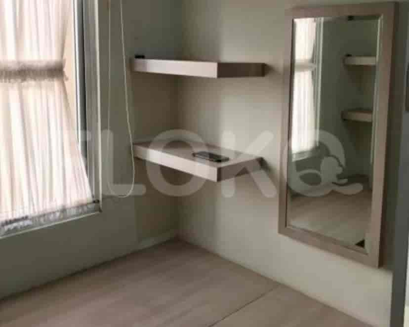 A view of a bedroom with shelves and a mirror.