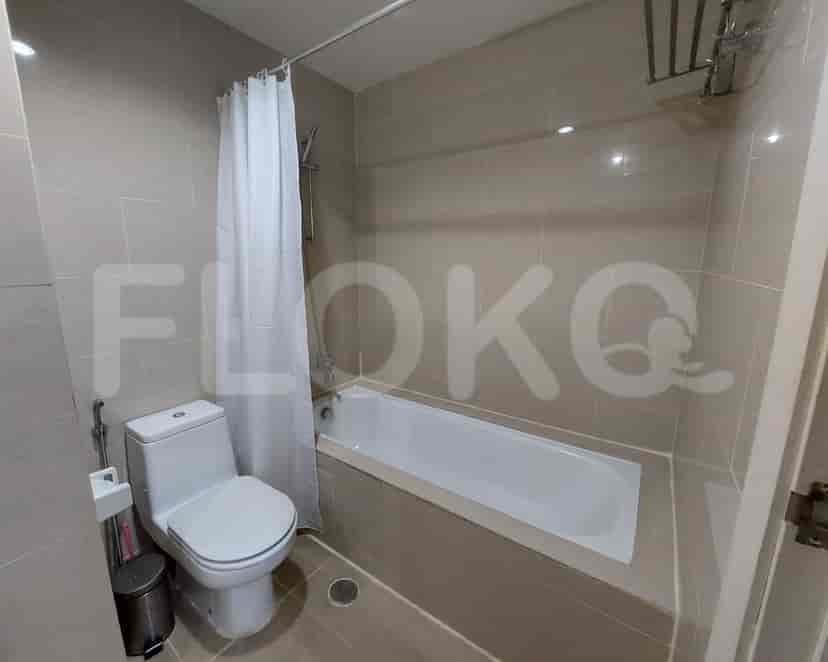 A bathroom featuring a bathtub, toilet, and shower curtain.