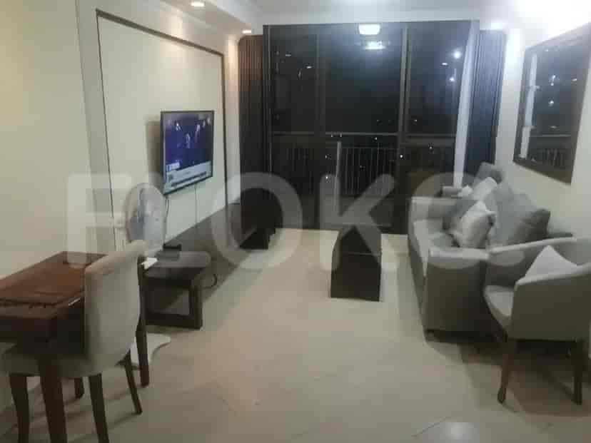 Living room with a dining area, sofa, and balcony view.
