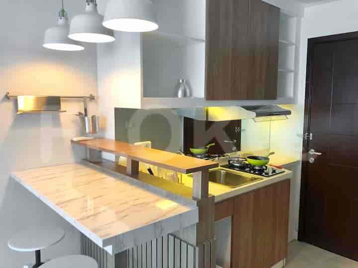 Kitchen setup with modern appliances and a breakfast bar.