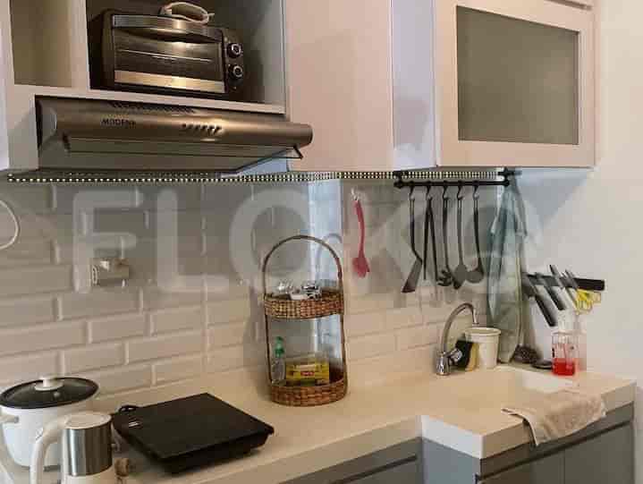 A close-up view of the kitchenette area, showcasing appliances and utensils.
