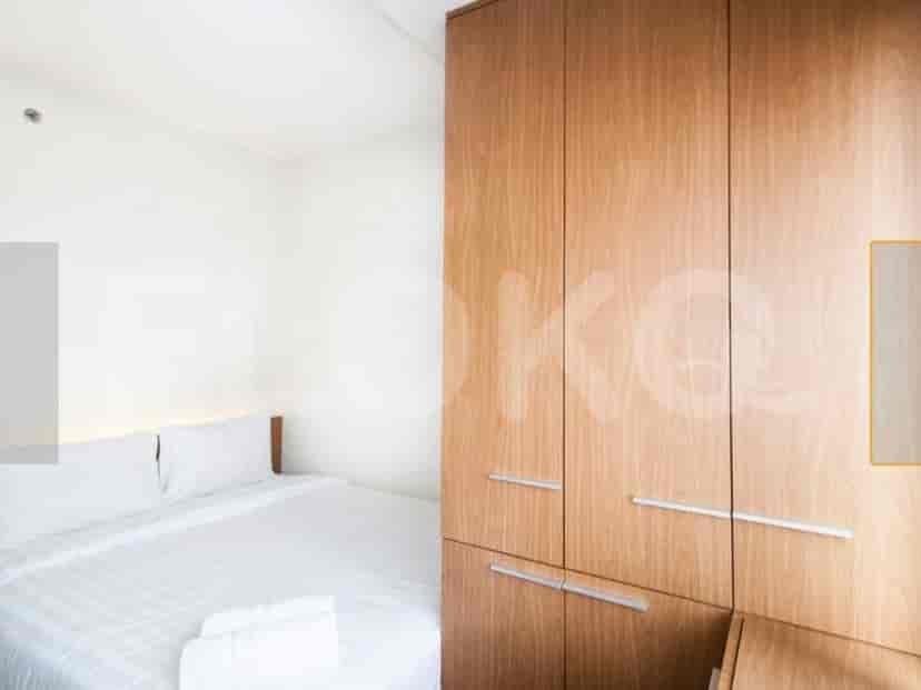 A bedroom with a bed and wardrobe.
