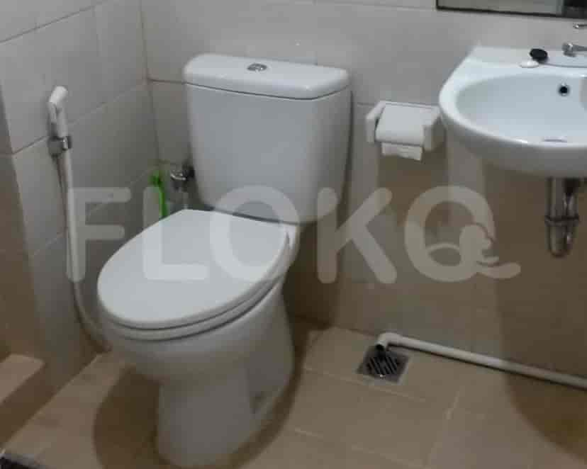 A small bathroom with a toilet and a sink.