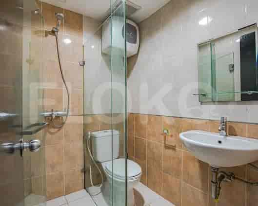 A bathroom with a shower, sink, and toilet.