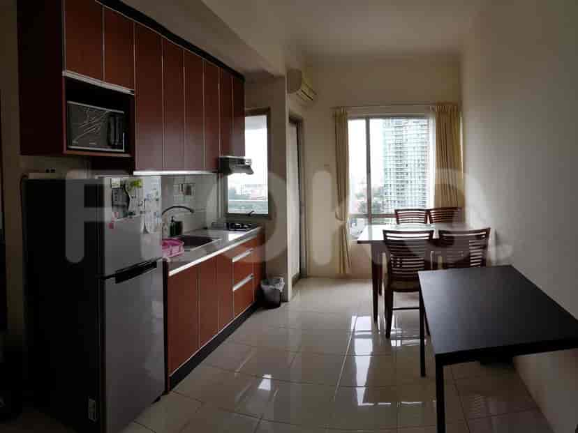 Modern kitchen with wooden cabinets, stainless steel appliances, and a dining area.