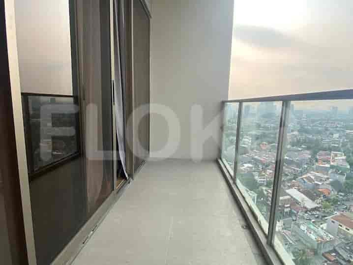 A balcony with a clear view of the city, featuring glass railings.