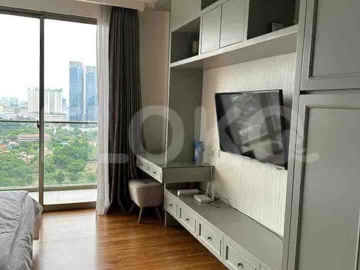 Bedroom with a large window offering city views, built-in dressing table, and integrated storage.