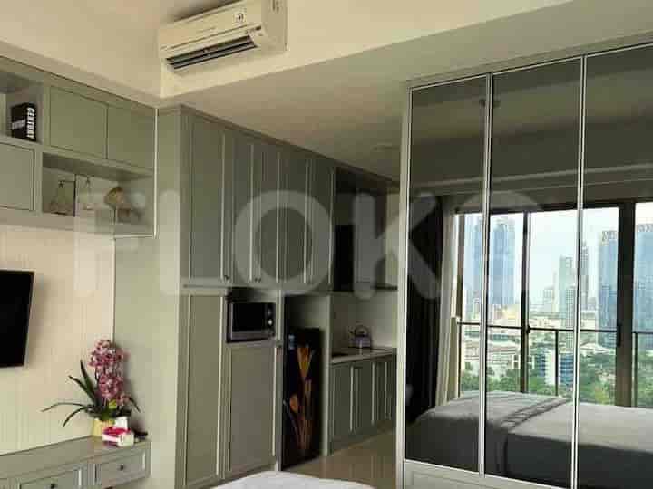 Bedroom with city views, featuring built-in storage with integrated kitchen elements, and large mirror closet doors.