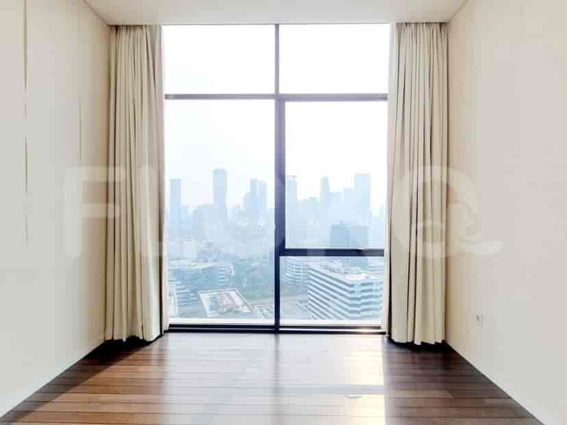 Room with a large window overlooking the city.