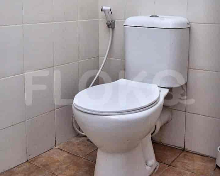 A simple bathroom with a toilet.
