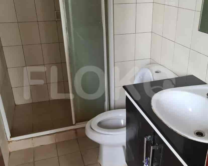 A modern bathroom with a sink, toilet, and shower enclosure.