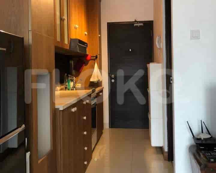 A modern kitchen with wooden cabinets, a countertop, and an open design.
