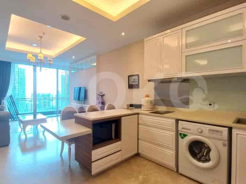 A combined kitchen and dining area featuring white cabinets, appliances, and a dining table.