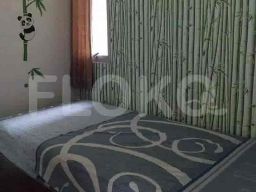 Bedroom with a bed and panda wall decor.
