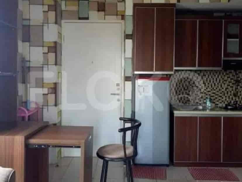 Kitchenette with table and appliances.