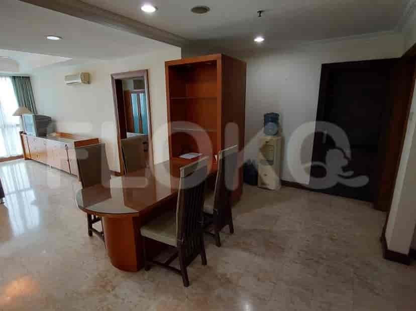 A dining area with a table, chairs, and a cabinet.