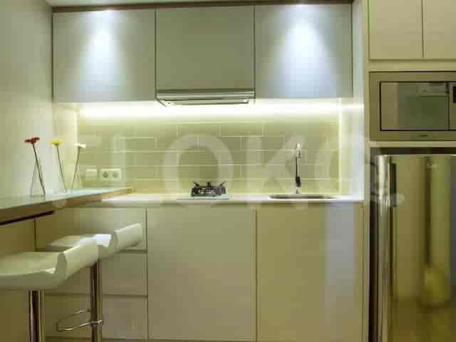 A small kitchen with modern appliances and bar seating.