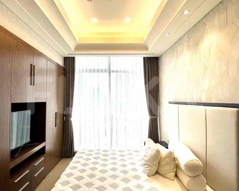 Cozy bedroom featuring a bed, modern design and decorative wallpaper.