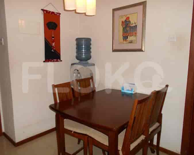 Cozy dining space with wooden table and chairs.
