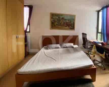 A bedroom featuring a bed, large window, and artwork.